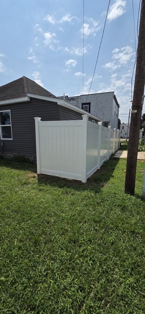 White vinyl privacy fence beside a house