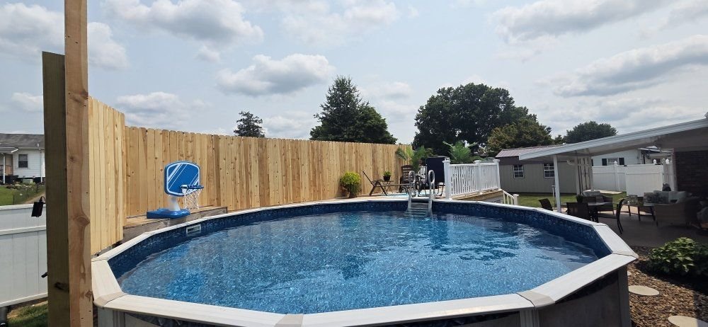 Wood privacy fence around a backyard pool